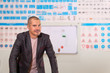 © Evgeny - man driving instructor on blurred background of the training room with traffic signs