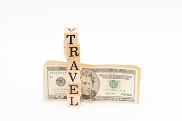 Wood block travel word with dollar banknote on white background