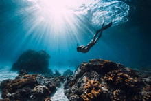 Woman Freediver With Fins Underwater. Freediving And Beautiful Light In Ocean