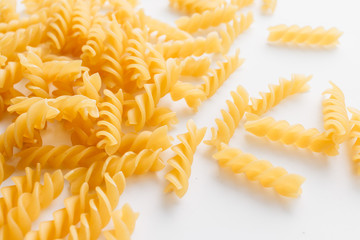 Wall Mural - Pile of uncooked macaroni on white background