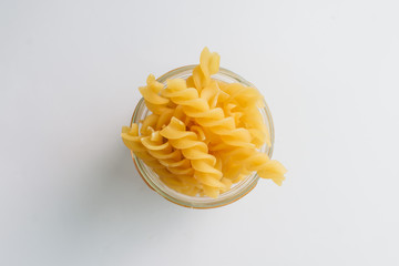 Wall Mural - Pile of uncooked macaroni on white background