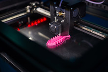 3D Printer Prints Physical 3D Model Of Pink Fish Skeleton At Modern Technology Exhibition. Additive Technologies, Science And Futuristic Concept