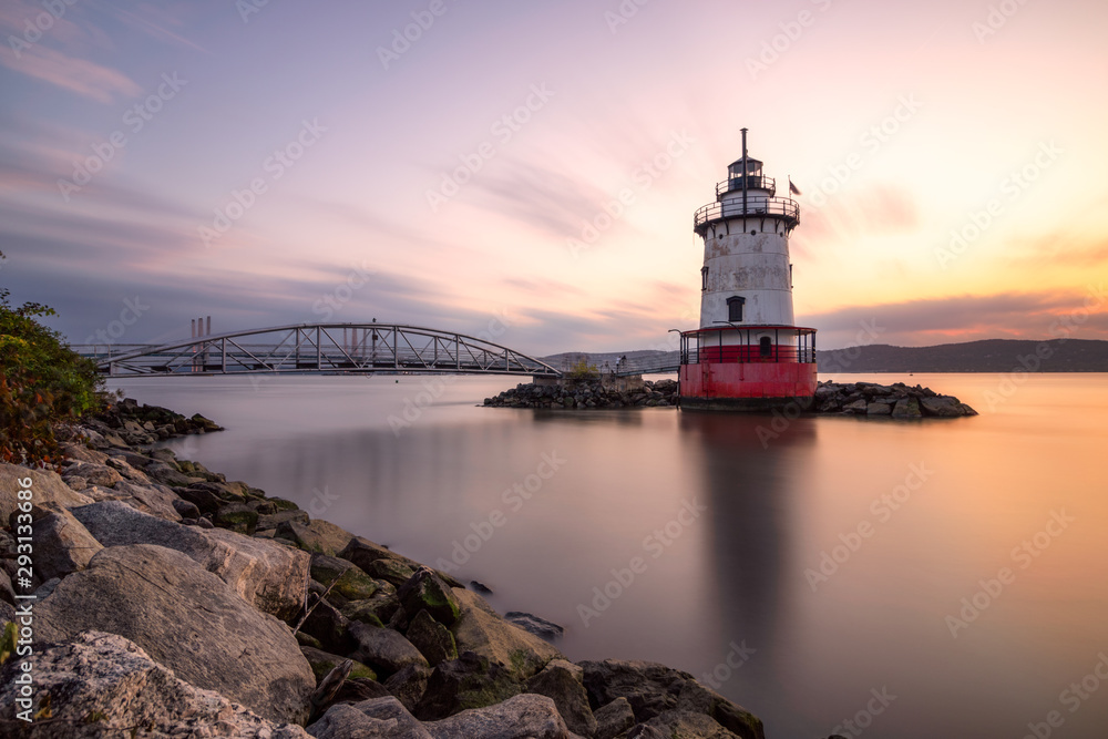 Caisson (sparkplug) style lighthouse under soft golden light with a bridge in the background. Tarrytown Light on the Hudson River in New York.  - obrazy, fototapety, plakaty 