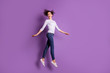 © deagreez - Full length body size photo of cheerful cute funny funky girlfriend wearing jeans denim sweater footwear jumping up isolated over purple pastel color background