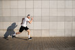 © opolja - Handsome man running in the city. Fitness, workout, sport, lifestyle concept.