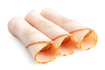 Wall Mural - Three rolled up slices of chicken ham isolated on white.