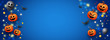 © Shi  - Happy Halloween website banner with scary face orange pumpkins, gold coins, bats and gold glitter elements on a blue background.