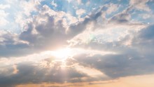 Timelapse: Sun Beams Shining Through Moving Dramatic White Clouds. Cloudy Blue Sky, Warm Sunrise Or Sunset Illumination, Sun Lens Flare. Time Lapse, Peaceful, Hope, Religion, Spiritual, Nature Concept