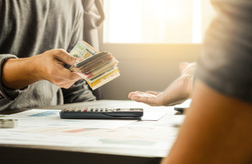 Sticker - Two businessmen give and take US dollar banknote  .US dollar is main and popular currency of exchange in the world.Investment and payment concept.