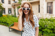 © Drobot Dean - Optimistic young redhead woman walking outdoors