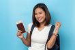 © suriya - Traveler tourist Asian women holding passport isolated on blue background , Travel Holiday Concept