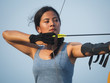 © chayathon2000 - Asian Archery woman with bow shooting on the beach