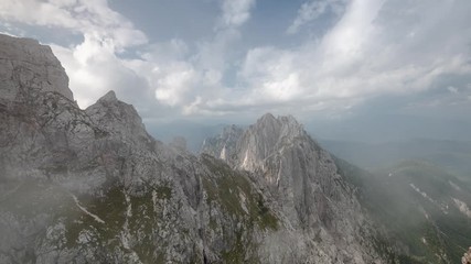 Sticker - Dramatic Clouds Moving Over Mountains Peak near Mangart in Slovenia Triglav National Park. 4K Time Lapse Footage.