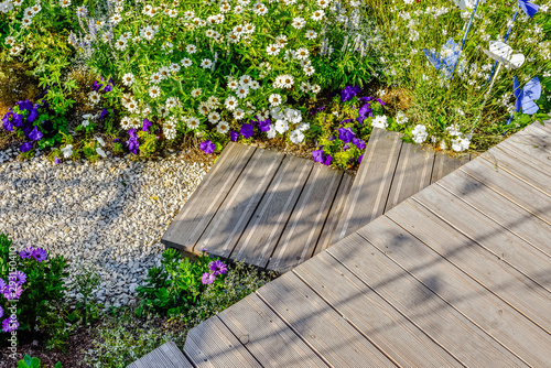 Fotomural beautiful terrace and wooden driveway in the blooming garden