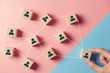 © oatawa - Building a strong team, Wooden blocks with people icon on blue and pink background, Human resources and management concept.