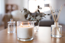 Decoration, Hygge And Aromatherapy Concept - Aroma Reed Diffuser, Burning Candle And Perfume On Table At Home