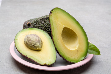 New harvest of fresh ripe hass avocado, cut in half