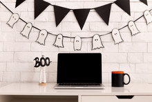 Workplace Decorating For Halloween Party With Open Laptop