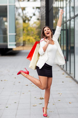 Wall Mural - Beautriful young woman with shopping bags on her hands smile