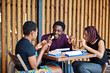 © AS Photo Family - Group of three african american friends play table games.