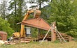 Excavator roof peak house demolition