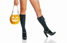 Beautiful Female Legs In Shoes Of Witch And Halloween Pumpkin.