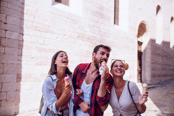 Wall Mural - Group of tourist eating ice cream at street