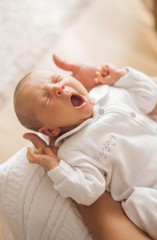 cute newborn baby sleeping in mother's arms. motherhood.