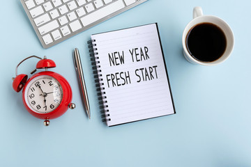 Wall Mural - New Year Fresh Start text on note pad, flat lay office desk.