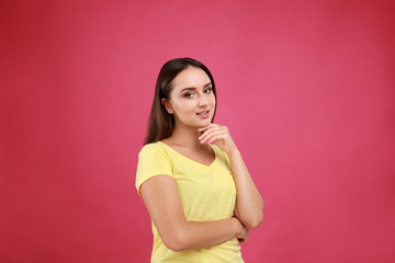 Wall Mural - Beautiful young woman in casual outfit on crimson background