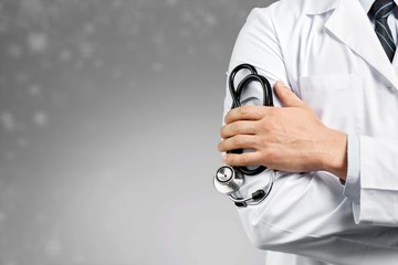 Wall Mural - Portrait of  doctor  with arms crossed in medical office