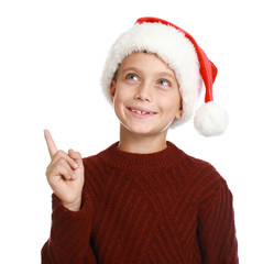 Wall Mural - Happy little child in Santa hat on white background. Christmas celebration