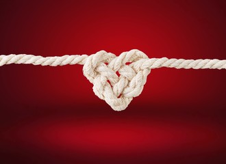 Canvas Print - White rope in heart shape knot on background. Love concept.