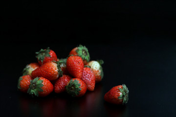 a pile of strawberry isolated on black background