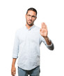© agongallud - Serious young man making a gesture of stop with his palm