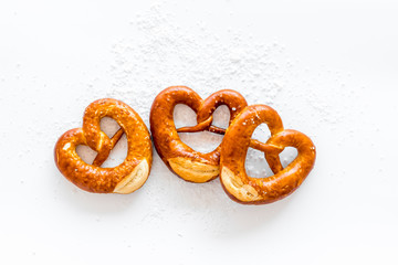 Wall Mural - Octoberfest symbol. Fresh bavarian pretzels on white background top view copy space