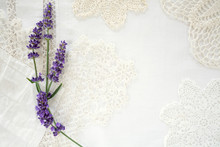 Pretty Lavender Flowers On Linen And Doilies Layered Background With Room For Copy Space