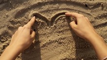 Woman Draw Heart Playing With The Sand On The Beach Finger Girl Hand Nature Summer Vacation Coast Coastline Holiday Ocean Relax Sunlight Concept Romantic Close Up Slow Motion