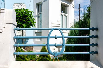 Wall Mural - Metal decorative blue fence near the house