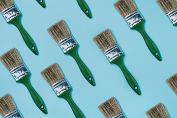 Summer subject photography. Paint brushes on a cyan-blue  background