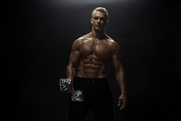 Fitness model man posing in studio