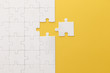© LIGHTFIELD STUDIOS - top view of white jigsaw puzzle on yellow background