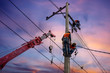 © mrpratan - Electrician lineman with cranes and hoists repairman worker at climbing work on electric post power pole