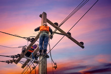 Electrician Lineman Repairman Worker At Climbing Work On Electric Post Power Pole