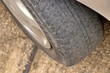 © virachit - Worn out tyre concept. Danger of using a worn out tyre with very little tread remaining.