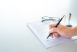 © Supagrit Ninkaesorn - White table with paper contract detail and empty space to sign authorized signature, props with glasses and ink pen, Hand holding object, copy space available for text