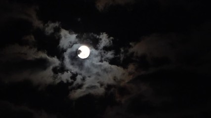dark night black sky clouds moving quickly across full moon