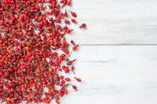 Berries Of Red Rose Hips Useful For Health On A Wooden Surface