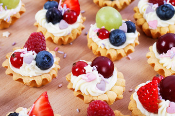 Wall Mural - Colorful cupcakes with fresh fruits.