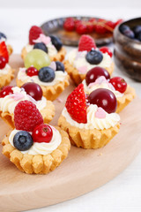 Wall Mural - Colorful cupcakes with fresh fruits.